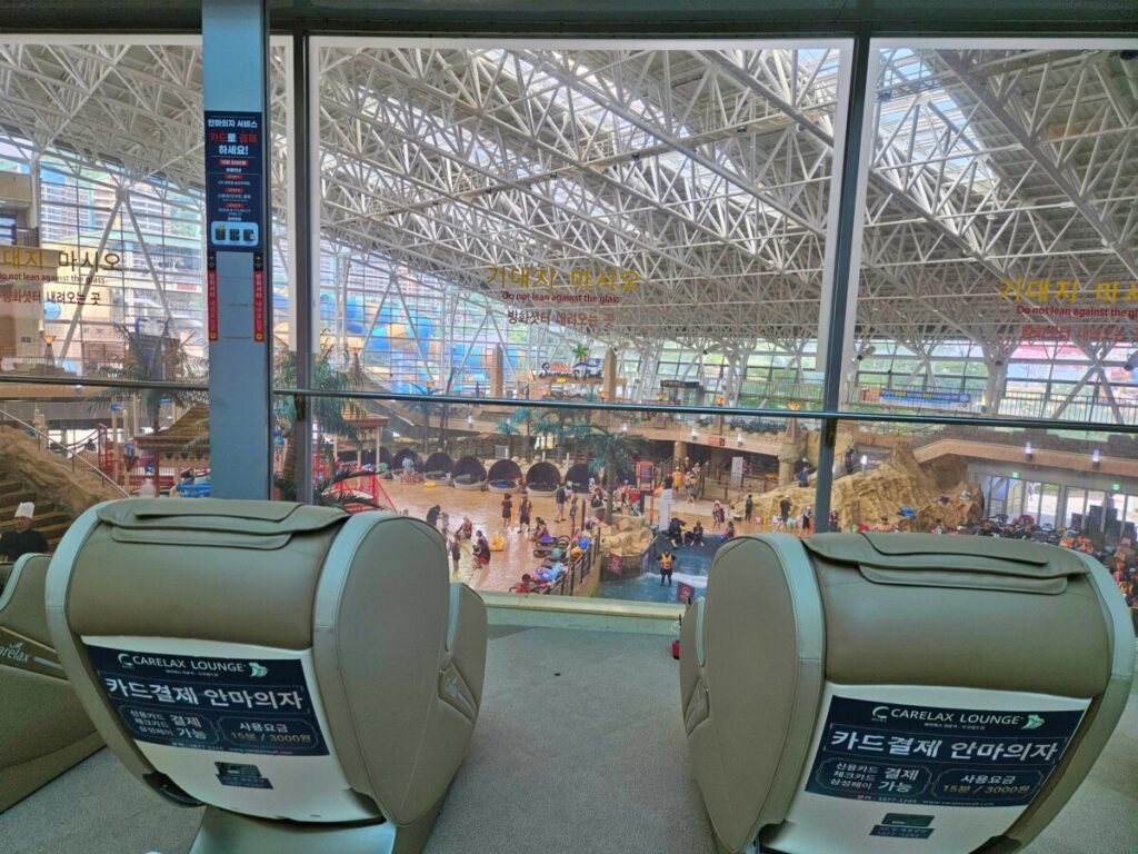 Relax lounge massage chairs with indoor pool view at Ocean World Korea