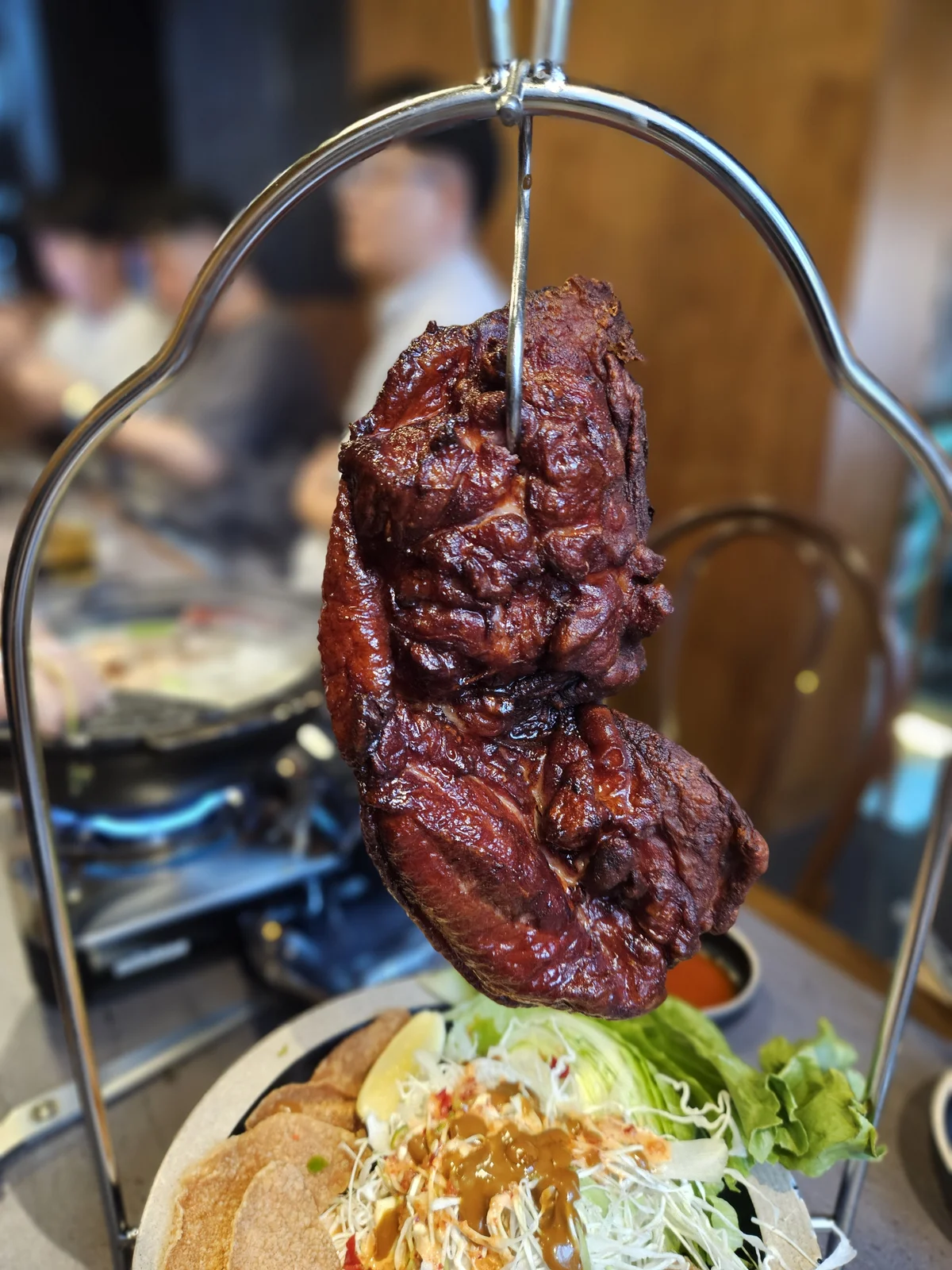 Clay-baked duck on a hanging skewer at Ari Valley, a Korean pub Seoul locals love