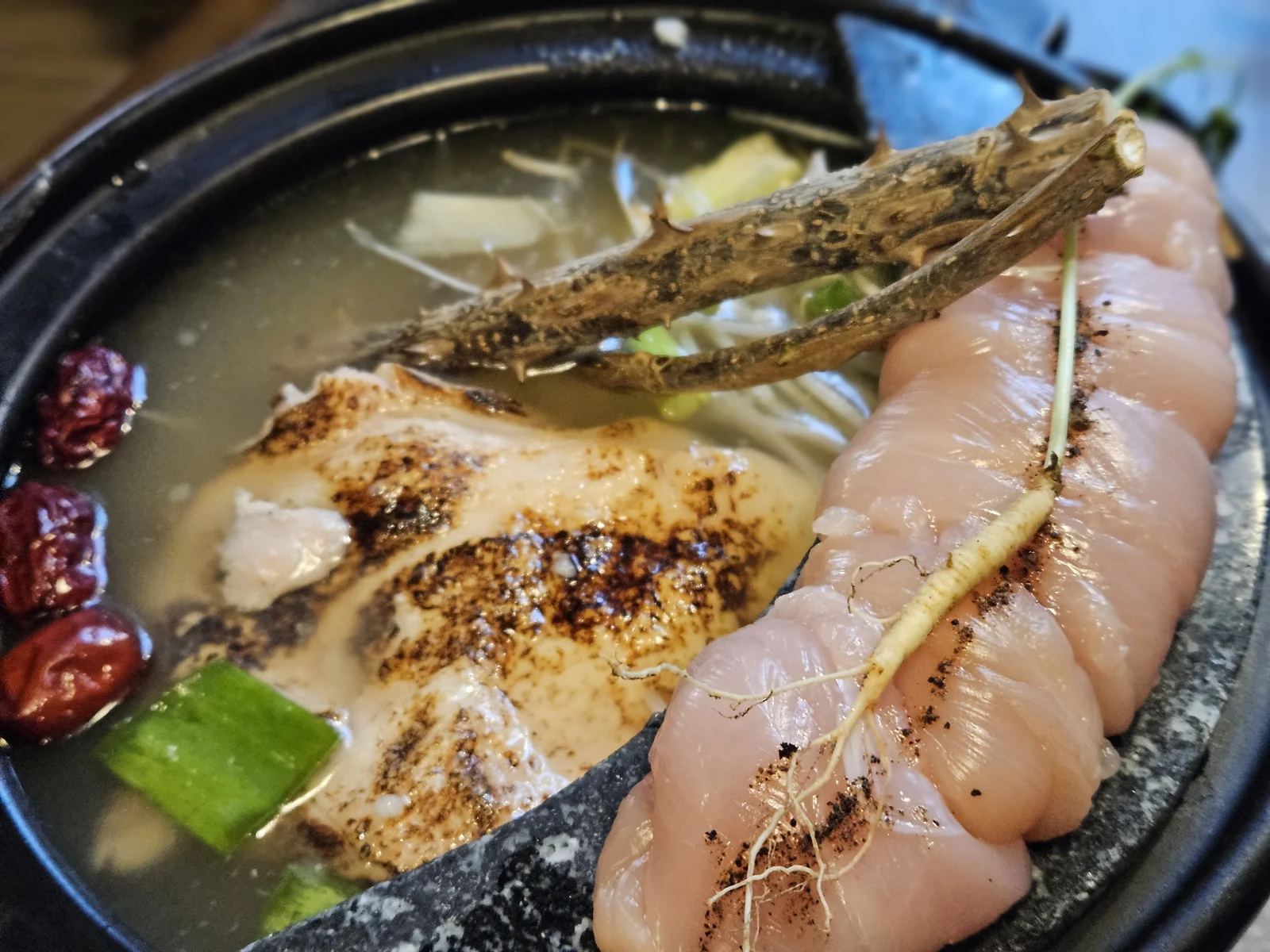 Dak jeongol chicken hot pot with fresh ginseng and jujubes before cooking