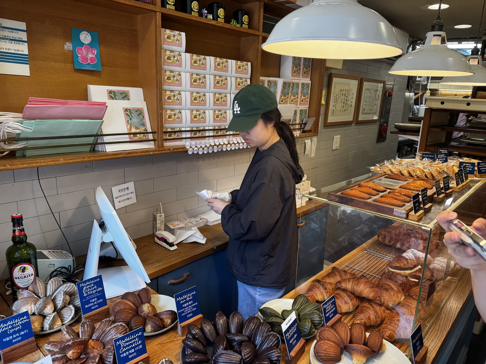 The tiny counter inside Etoile Garosugil packed with gift boxes and croissants