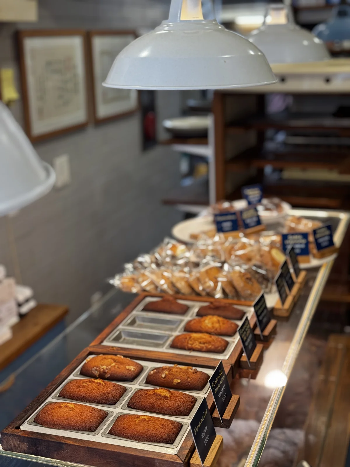 Freshly baked financiers in wooden molds at Etoile Garosugil bakery counter
