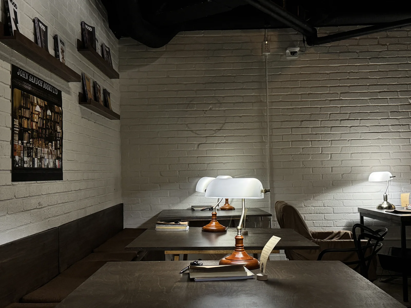 Banker's lamps light quiet reading desks at Jeokon book bar in Seoul